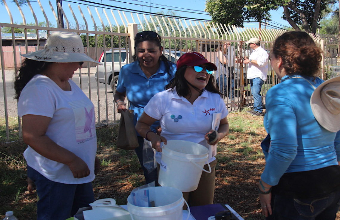 Photograph of Project Harvest promotoras and principal investigators passing out sampling materials.