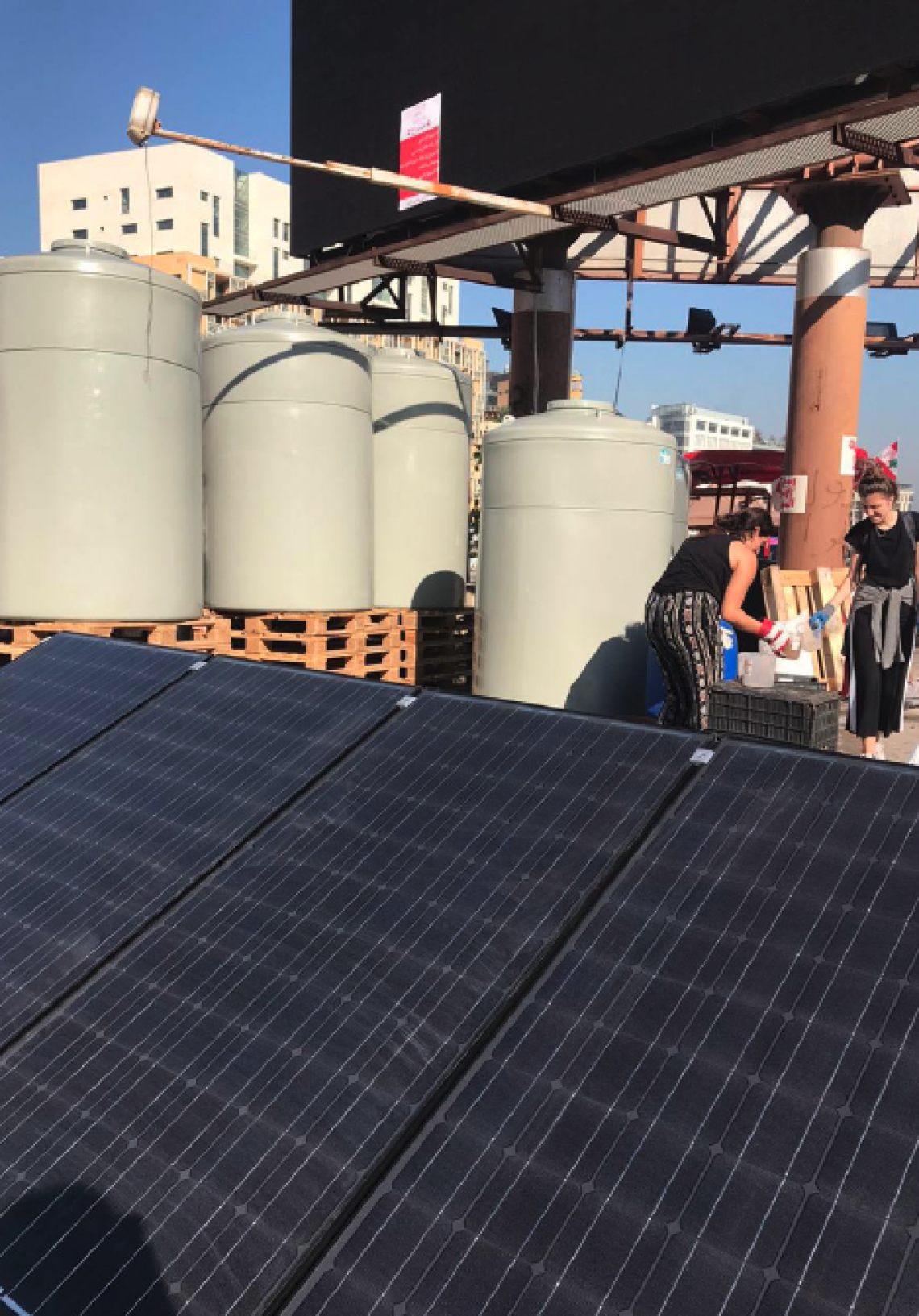 Solar panels and water tanks set up by Regenerate Lebanon and partners